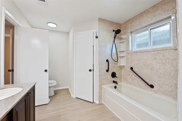 a bathroom with a tub sink and toilet