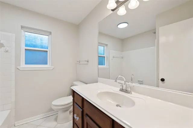 a bathroom with a sink toilet and vanity