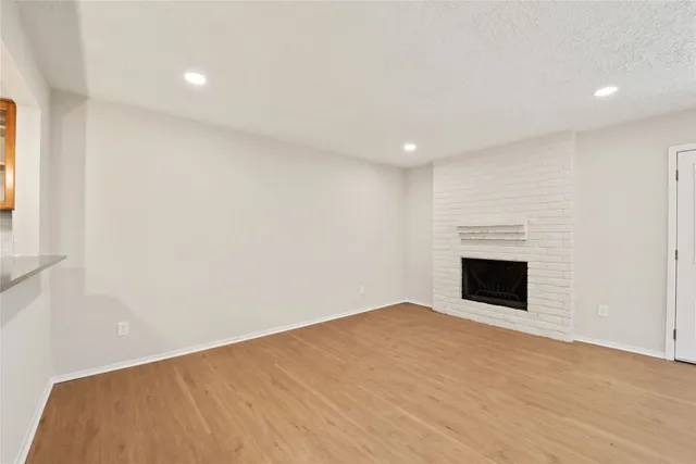 wooden floor in an empty room with a fireplace