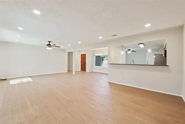 a view of a kitchen with a sink and a large mirror