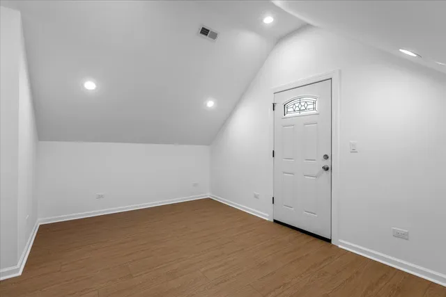 an empty room with wooden floor