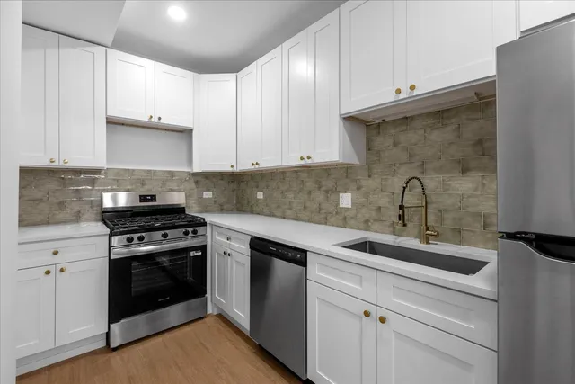 a kitchen with a sink stove and cabinets