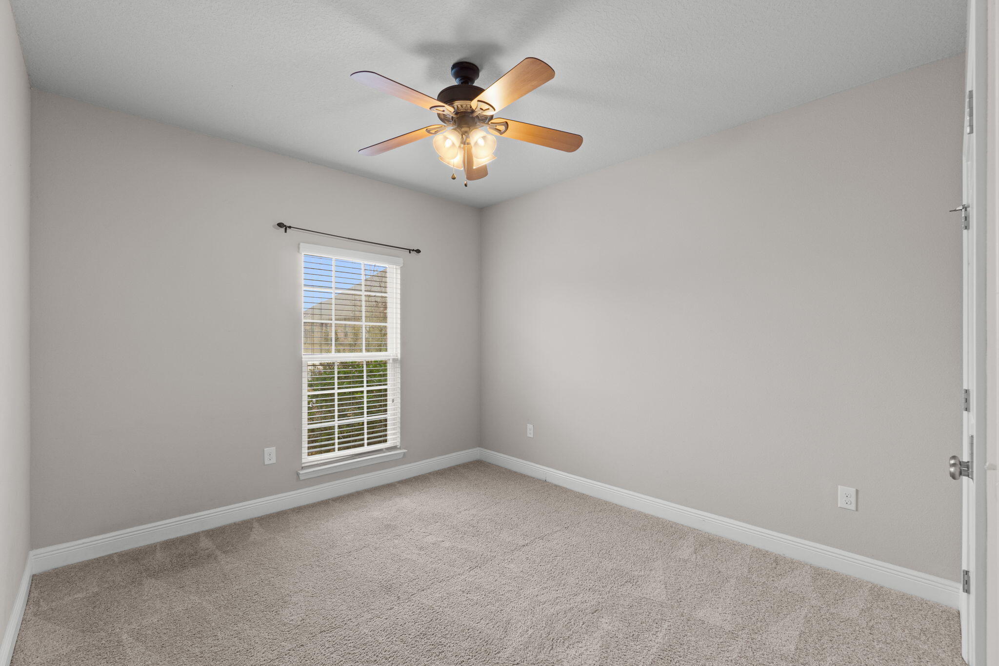 523 Gadwell Street Crestview, FL 32539 - Photo 11 of 28 an empty room with window and chandelier fan