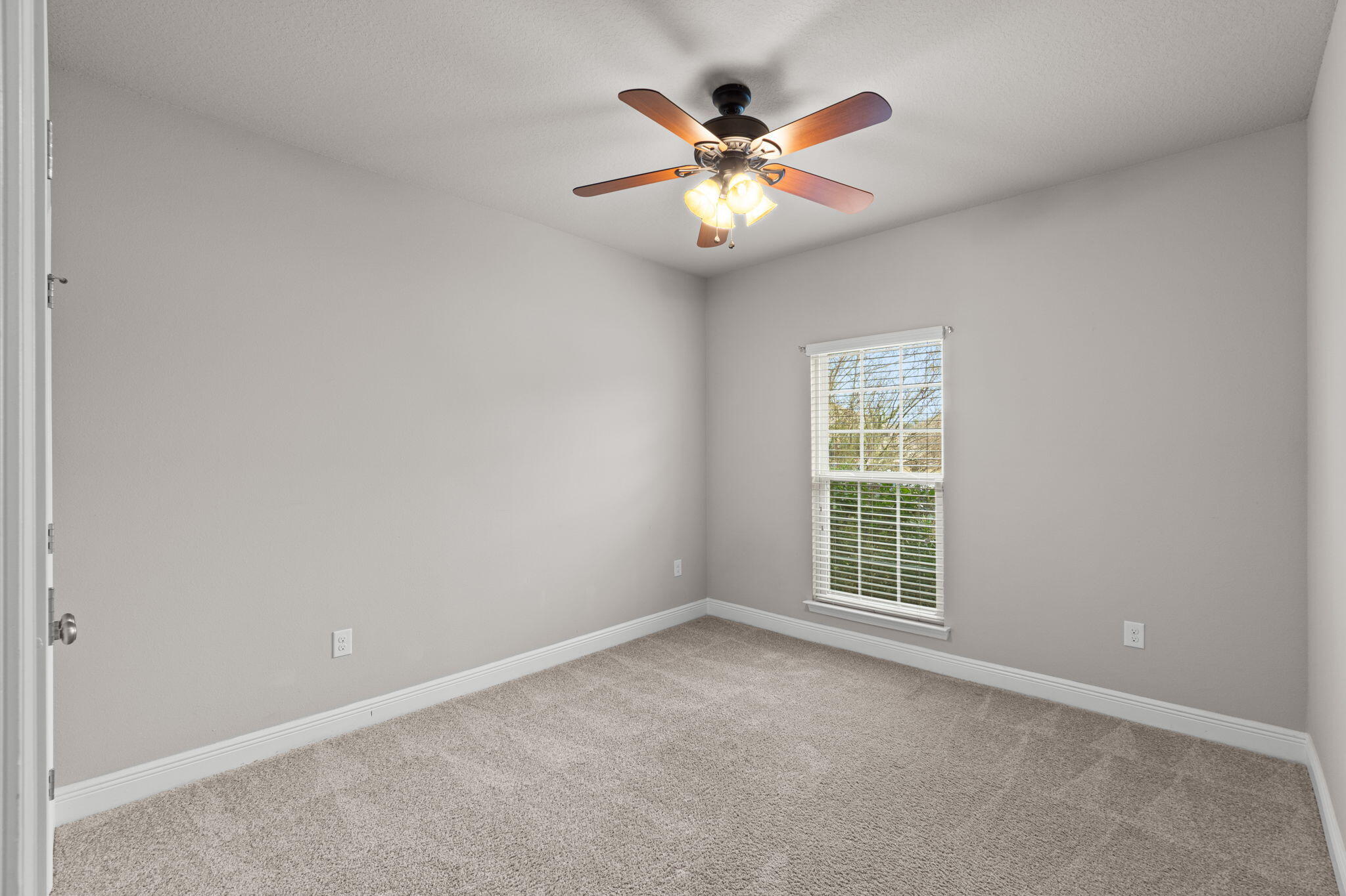 523 Gadwell Street Crestview, FL 32539 - Photo 13 of 28 an empty room with window and chandelier fan