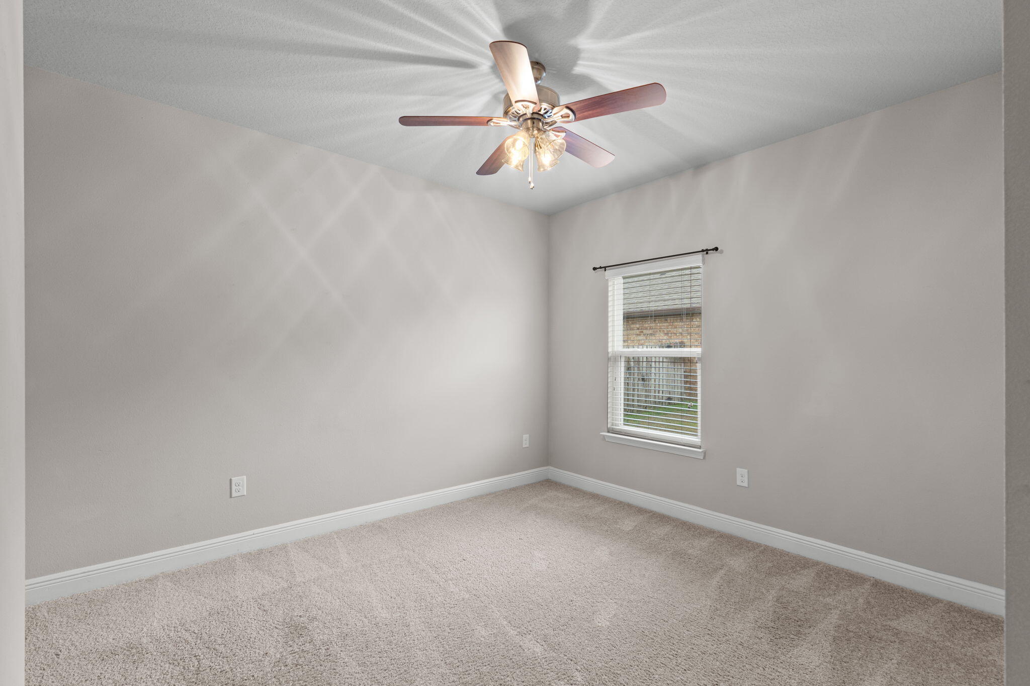 523 Gadwell Street Crestview, FL 32539 - Photo 16 of 28 an empty room with windows and fan