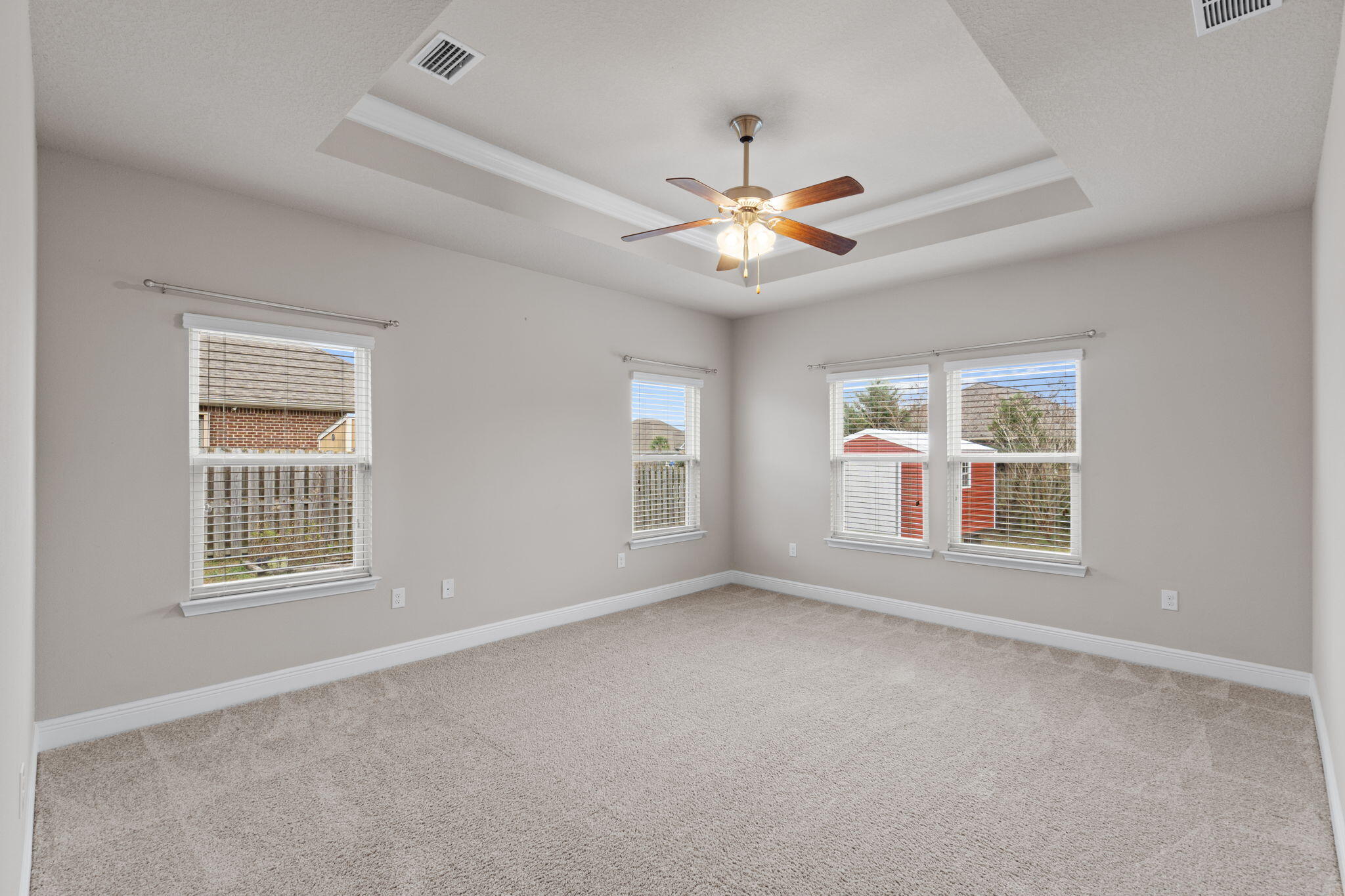 523 Gadwell Street Crestview, FL 32539 - Photo 18 of 28 an empty room with chandelier fan and windows