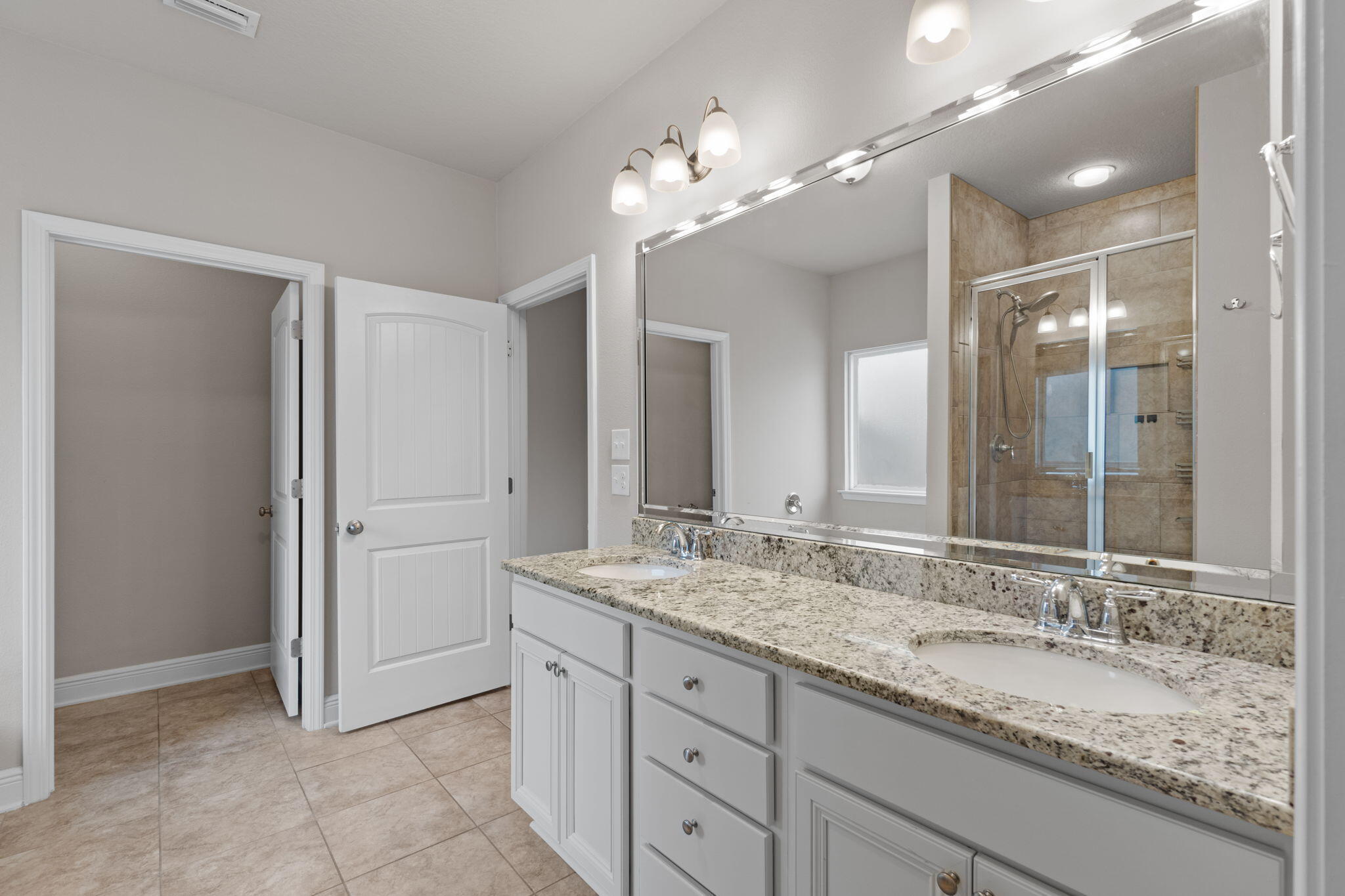 523 Gadwell Street Crestview, FL 32539 - Photo 21 of 28 a bathroom with a granite countertop double vanity sink and a mirror