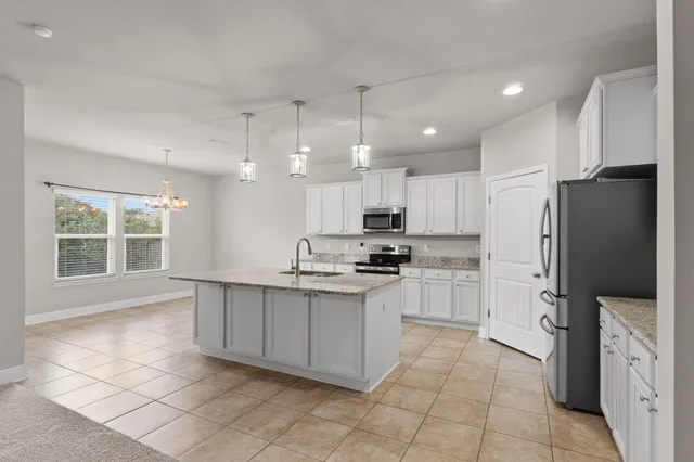 a large kitchen with cabinets and stainless steel appliances