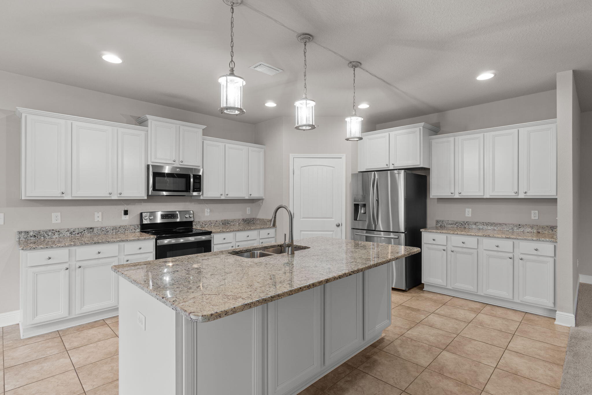 523 Gadwell Street Crestview, FL 32539 - Photo 7 of 28 a kitchen with kitchen island granite countertop stainless steel appliances a sink a stove a microwave a center island and cabinets