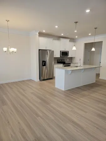a kitchen with kitchen island a counter top space appliances and cabinets