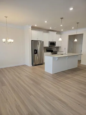 a kitchen with kitchen island a counter top space appliances and cabinets