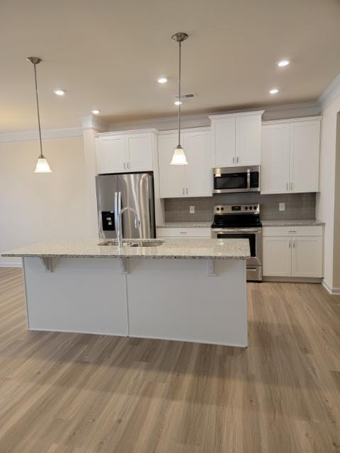 160 Madison Bend Holly Springs, GA 30115 - Photo 14 of 15 a kitchen with kitchen island a counter top space appliances and cabinets