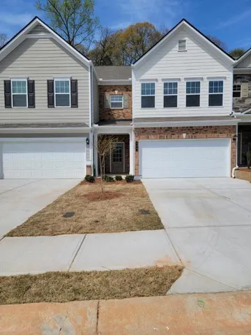 a front view of a house with yard