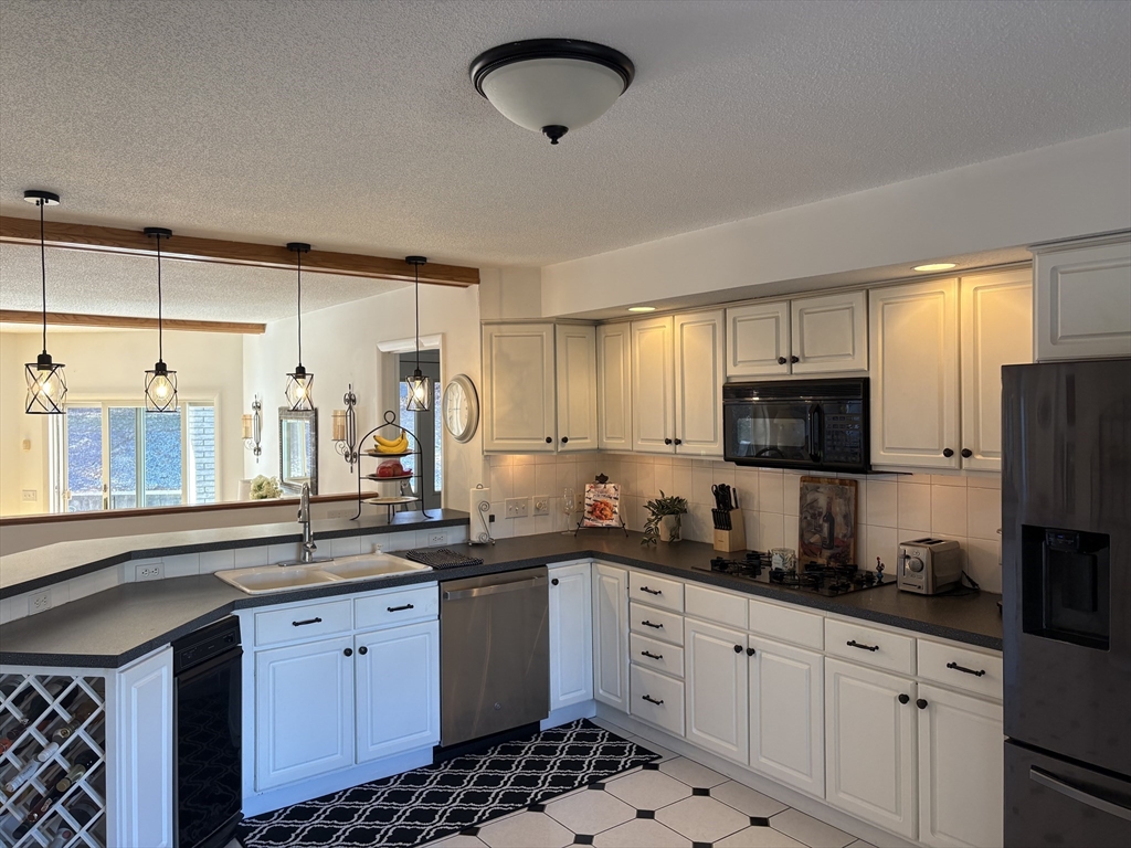 321 Westerly Circle Ludlow, MA 01056 - Photo 12 of 38 a kitchen with granite countertop a sink stainless steel appliances and cabinets