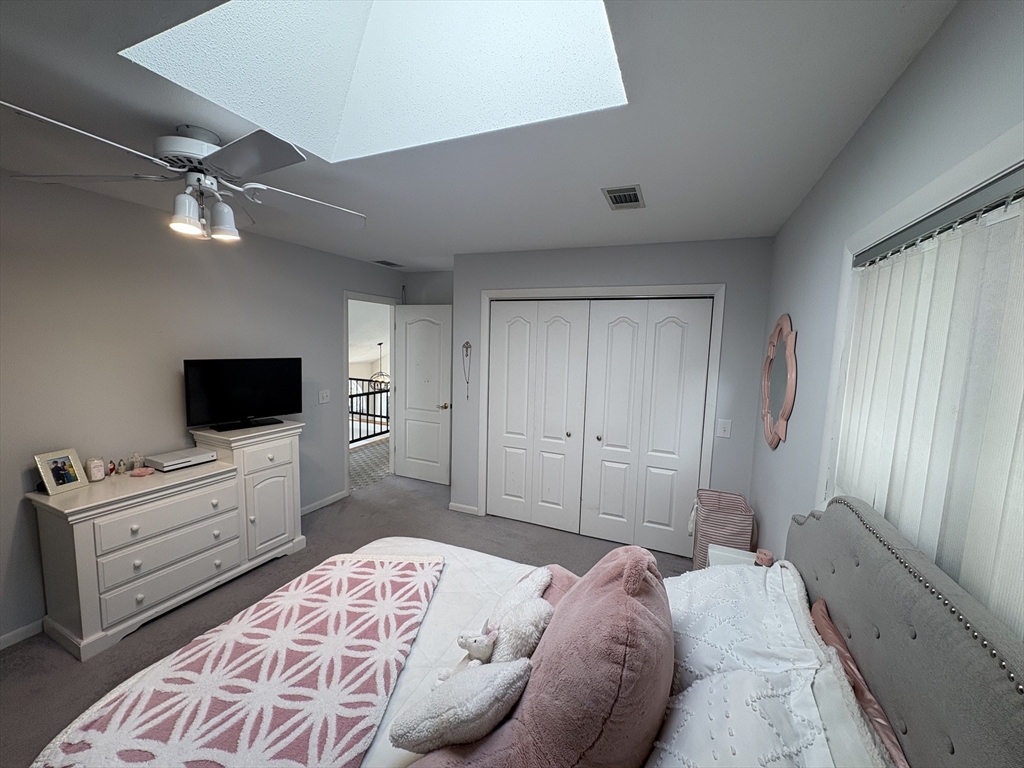 321 Westerly Circle Ludlow, MA 01056 - Photo 25 of 38 a bedroom with a bed and a flat screen tv