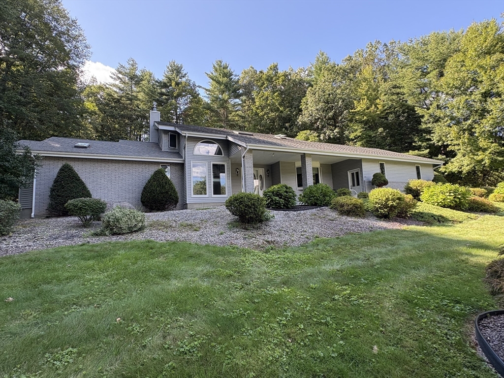 321 Westerly Circle Ludlow, MA 01056 - Photo 3 of 38 a view of a house with a yard and plants