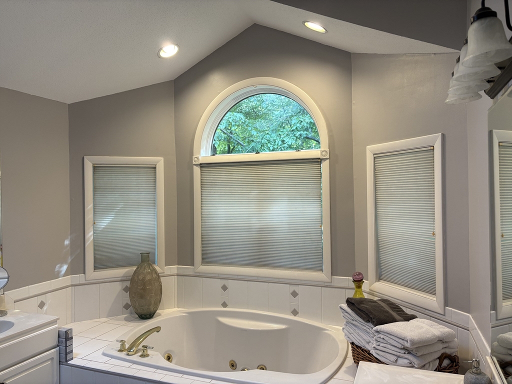 321 Westerly Circle Ludlow, MA 01056 - Photo 32 of 38 a bathroom with a tub a sink and a window