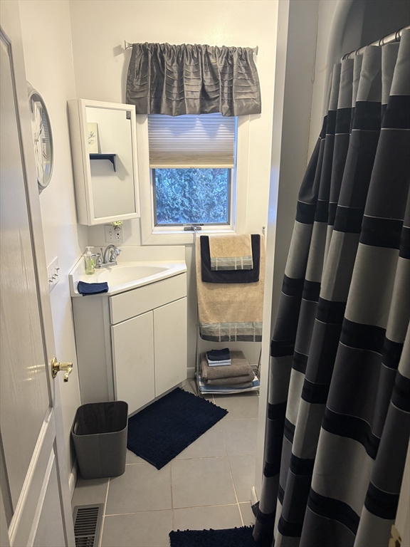 321 Westerly Circle Ludlow, MA 01056 - Photo 10 of 38 a bathroom with a sink and a mirror