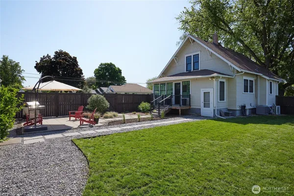 a view of a house with backyard sitting area and garden
