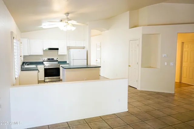 a view of kitchen with stainless steel appliances a refrigerator and a stove top oven