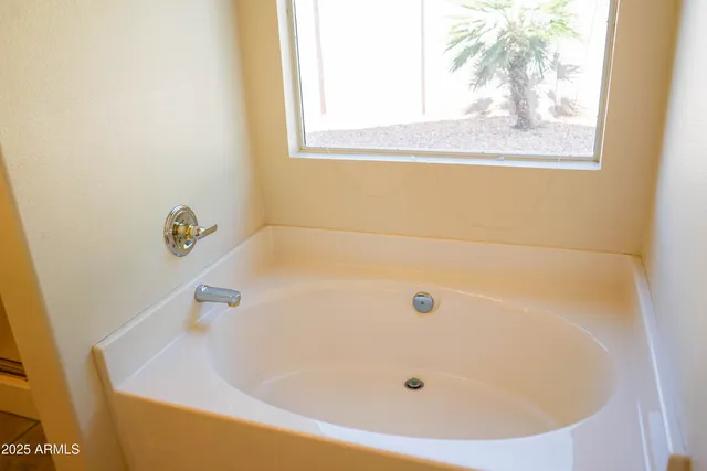 a bathroom with a shower and a mirror