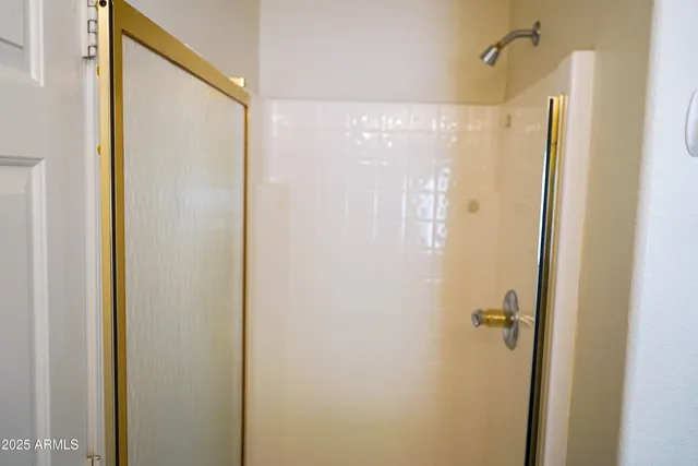 a view of a livingroom with a chandelier fan and a window