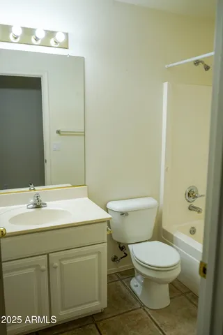 a view of a bathroom with a shower and a mirror