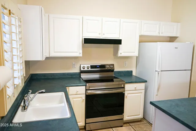 a kitchen with cabinets and white appliances