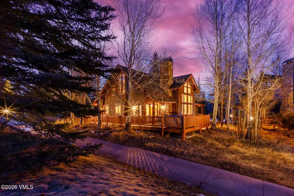 a view of a yard with large trees