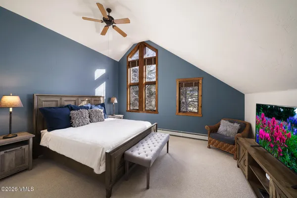 a bedroom with a bed couch and a window