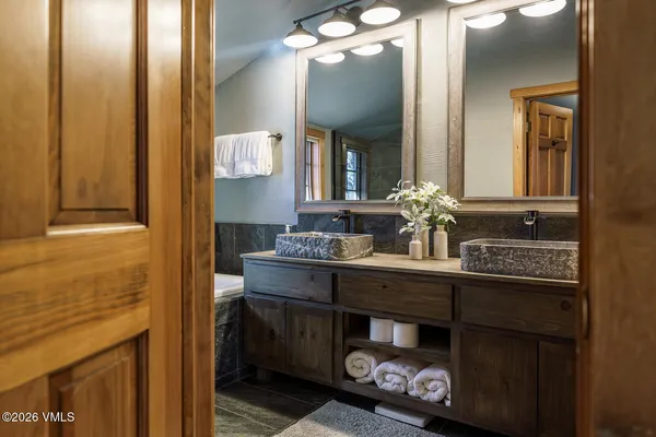 a bathroom with a double vanity sink and a mirror