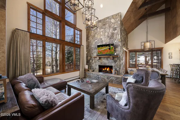 a living room with fireplace furniture and a floor to ceiling window