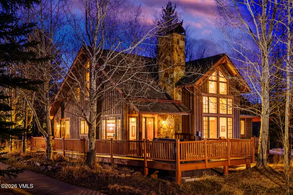a view of a porch with chairs and backyard