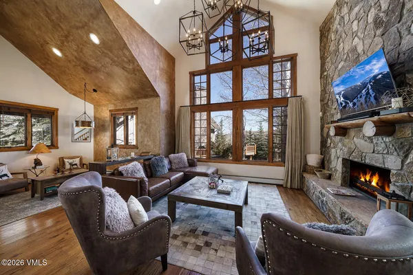 a living room with furniture fireplace and a large window