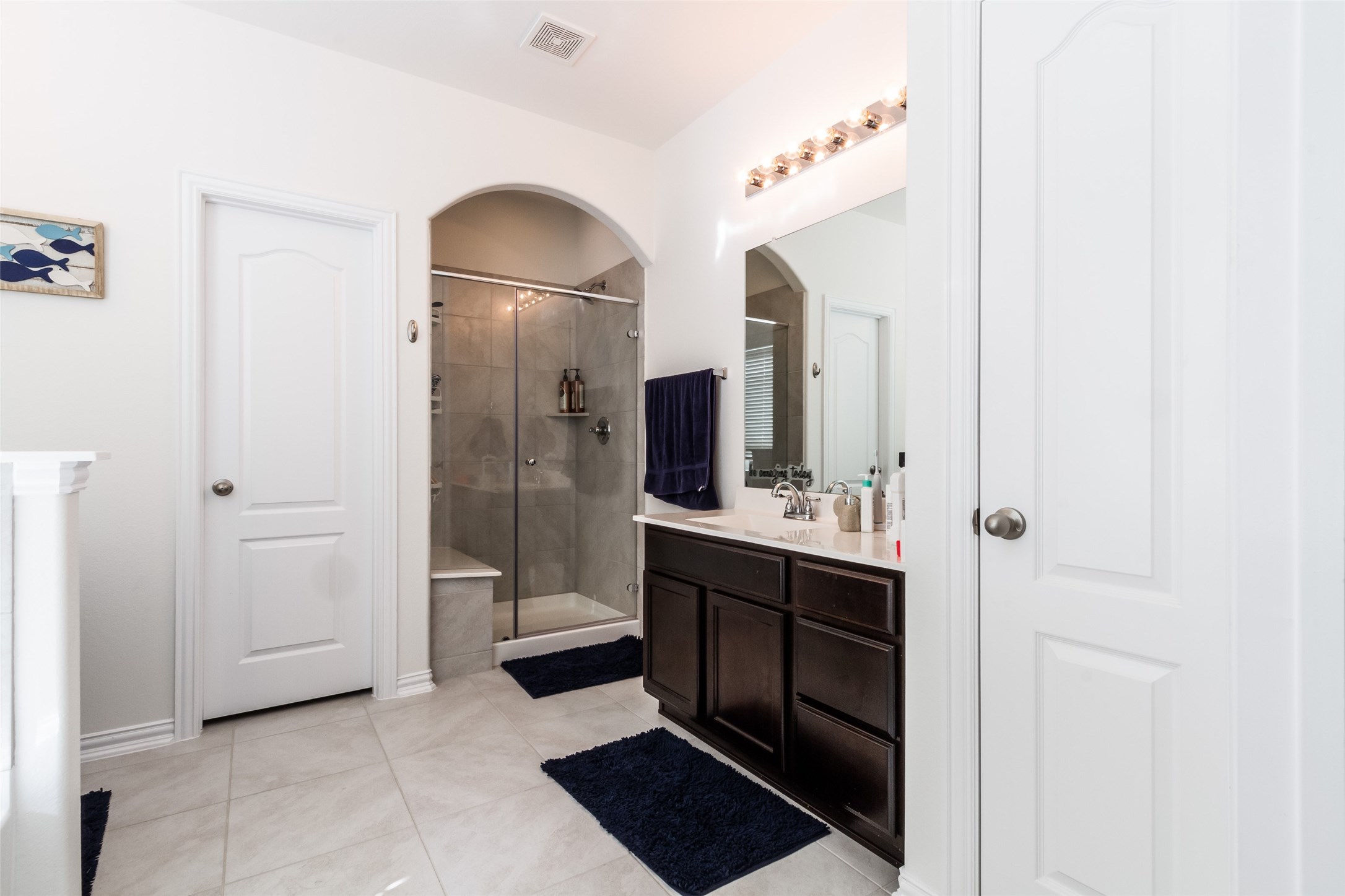 6305 Rotherham Street League City, TX 77573 - Photo 18 of 22 a bathroom with a sink and a mirror