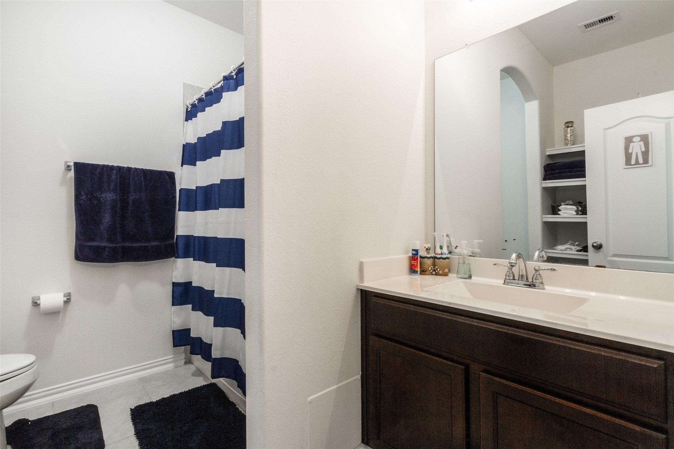6305 Rotherham Street League City, TX 77573 - Photo 5 of 22 a bathroom with a sink a toilet and shower