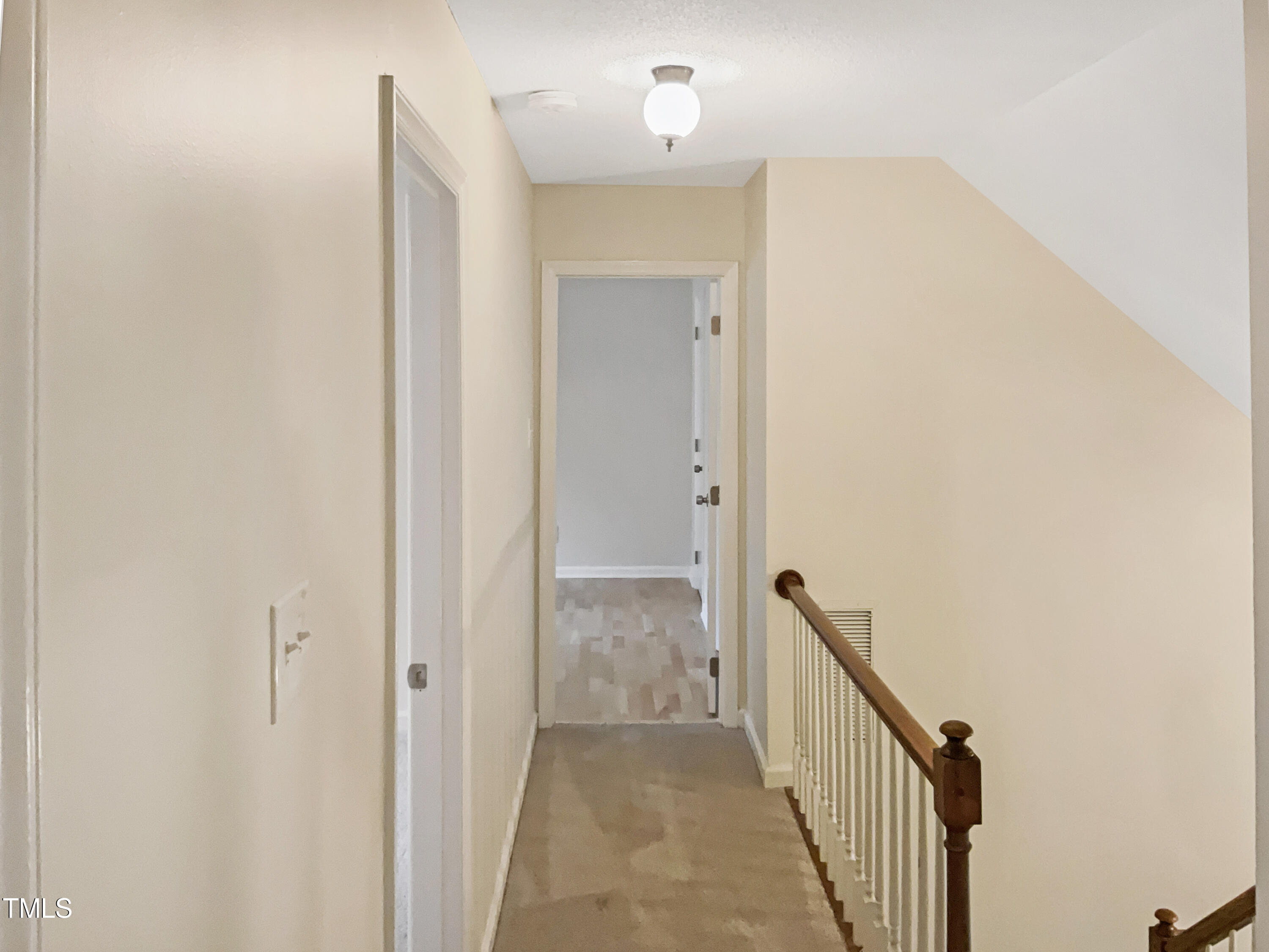 6008 Burgundy Road Durham, NC 27712 - Photo 28 of 40 a view of a hallway with wooden floor and staircase