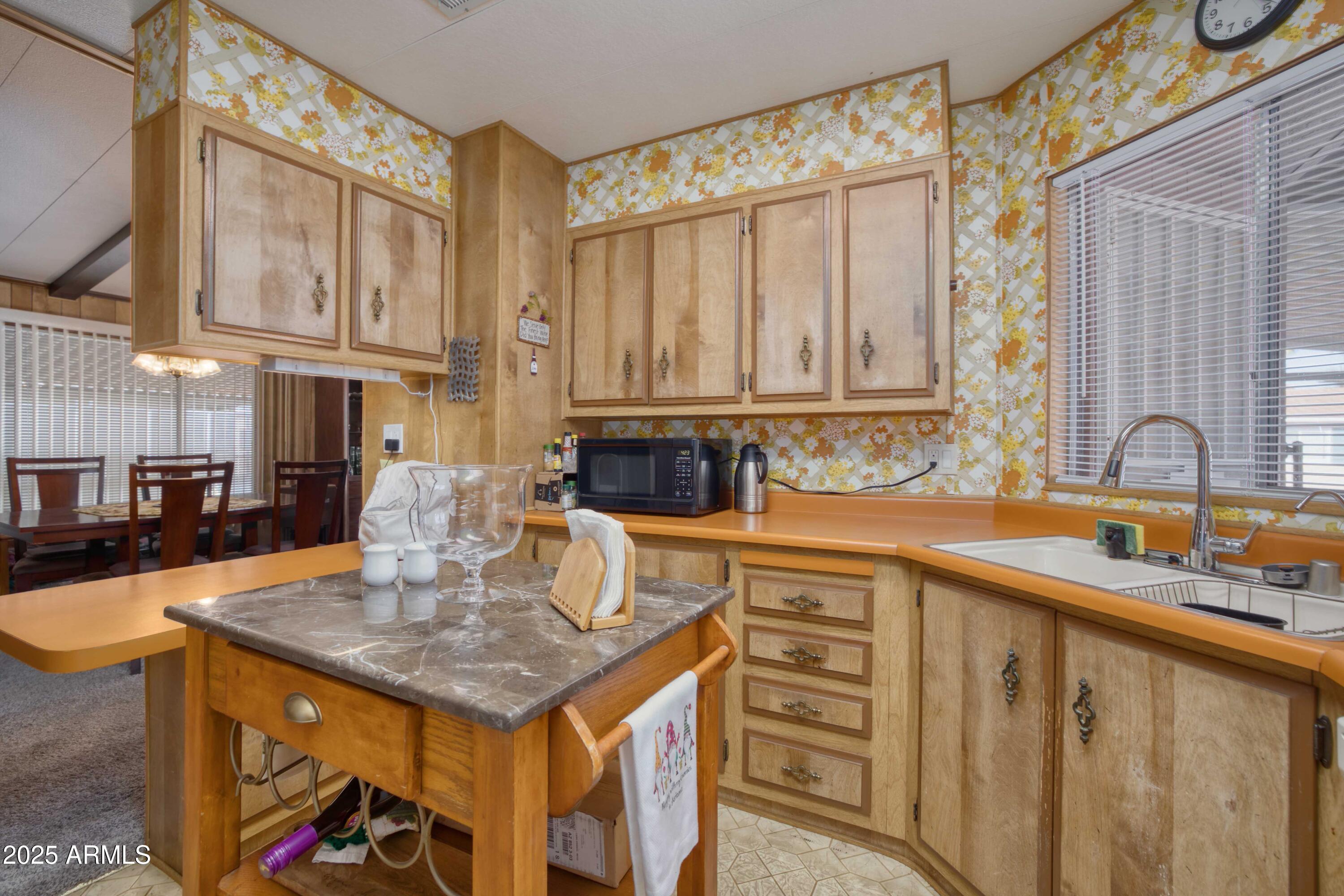 9302 East Broadway Road, Unit 185 Mesa, AZ 85208 - Photo 15 of 24 a kitchen with a stove a sink and cabinets