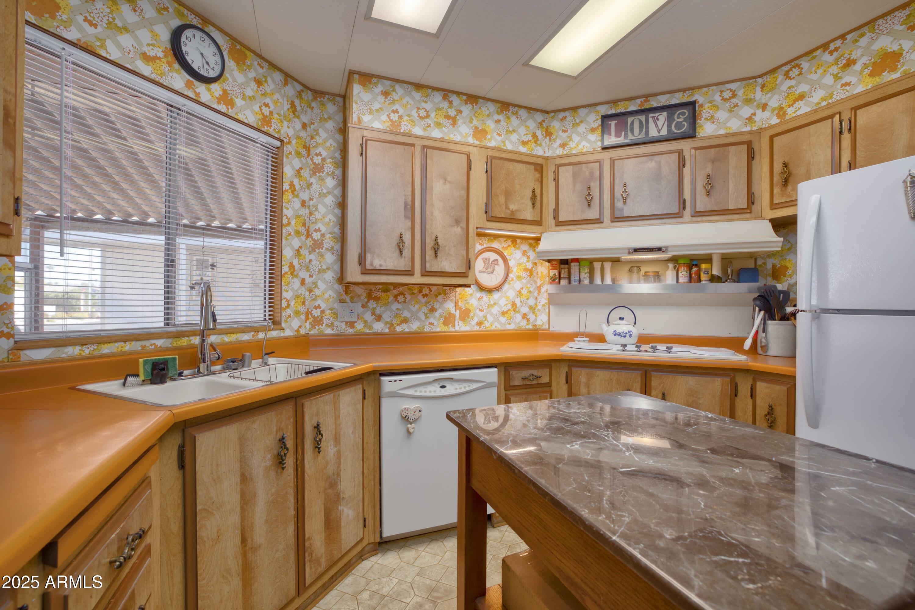 9302 East Broadway Road, Unit 185 Mesa, AZ 85208 - Photo 17 of 24 a kitchen with stainless steel appliances granite countertop a sink a stove and a refrigerator