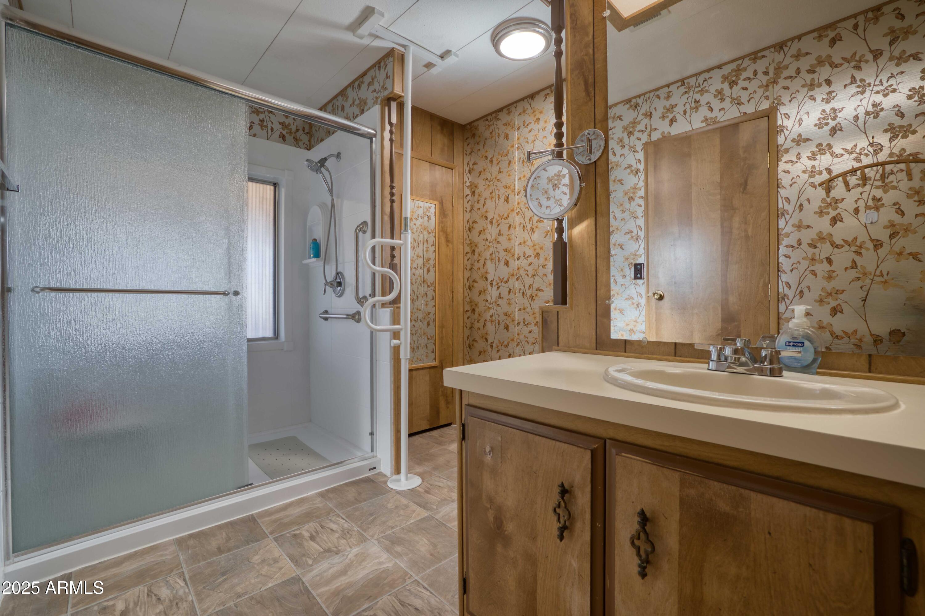 9302 East Broadway Road, Unit 185 Mesa, AZ 85208 - Photo 5 of 24 a bathroom with a sink and a mirror