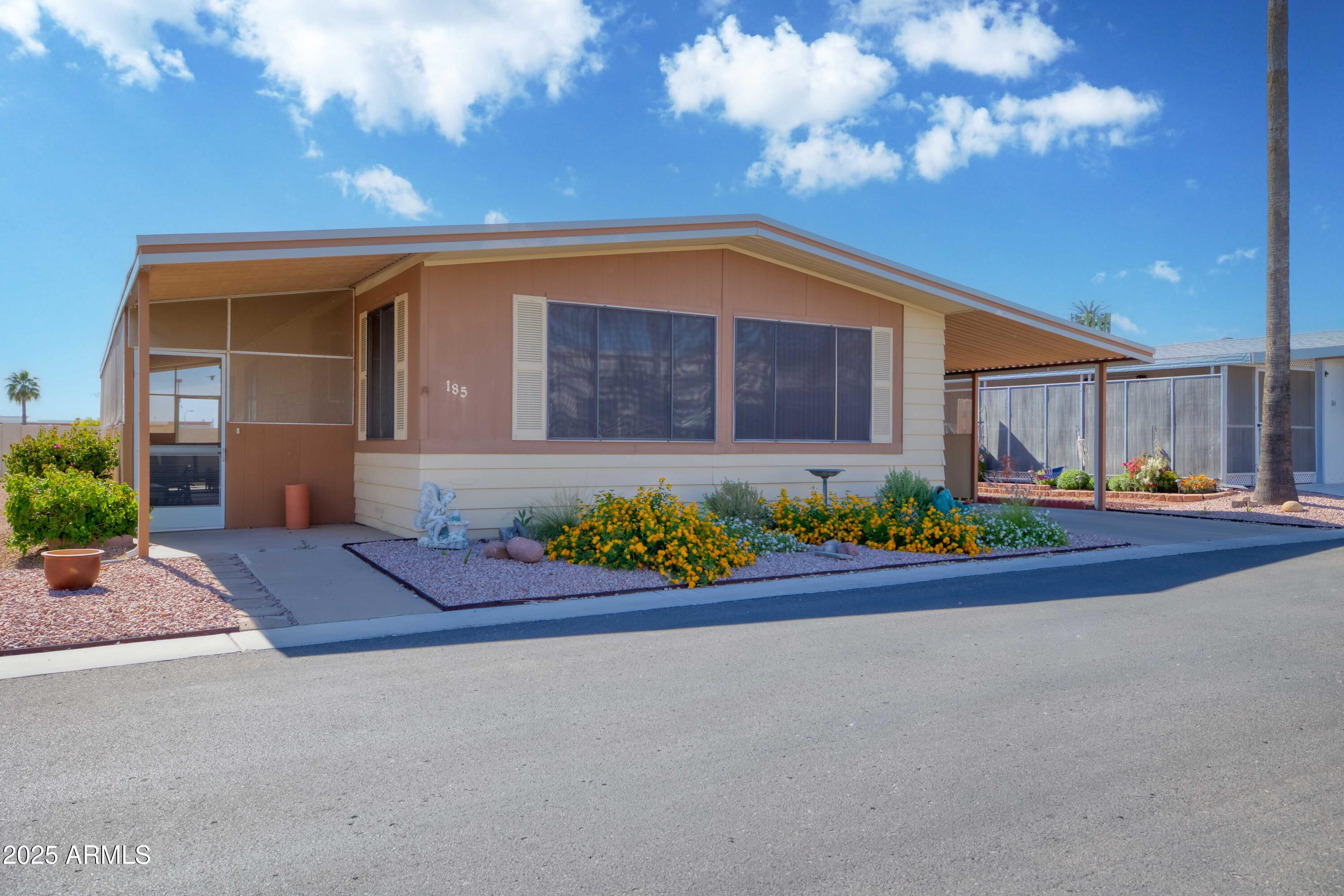 9302 East Broadway Road, Unit 185 Mesa, AZ 85208 - Photo 6 of 24 a front view of house with yard and green space