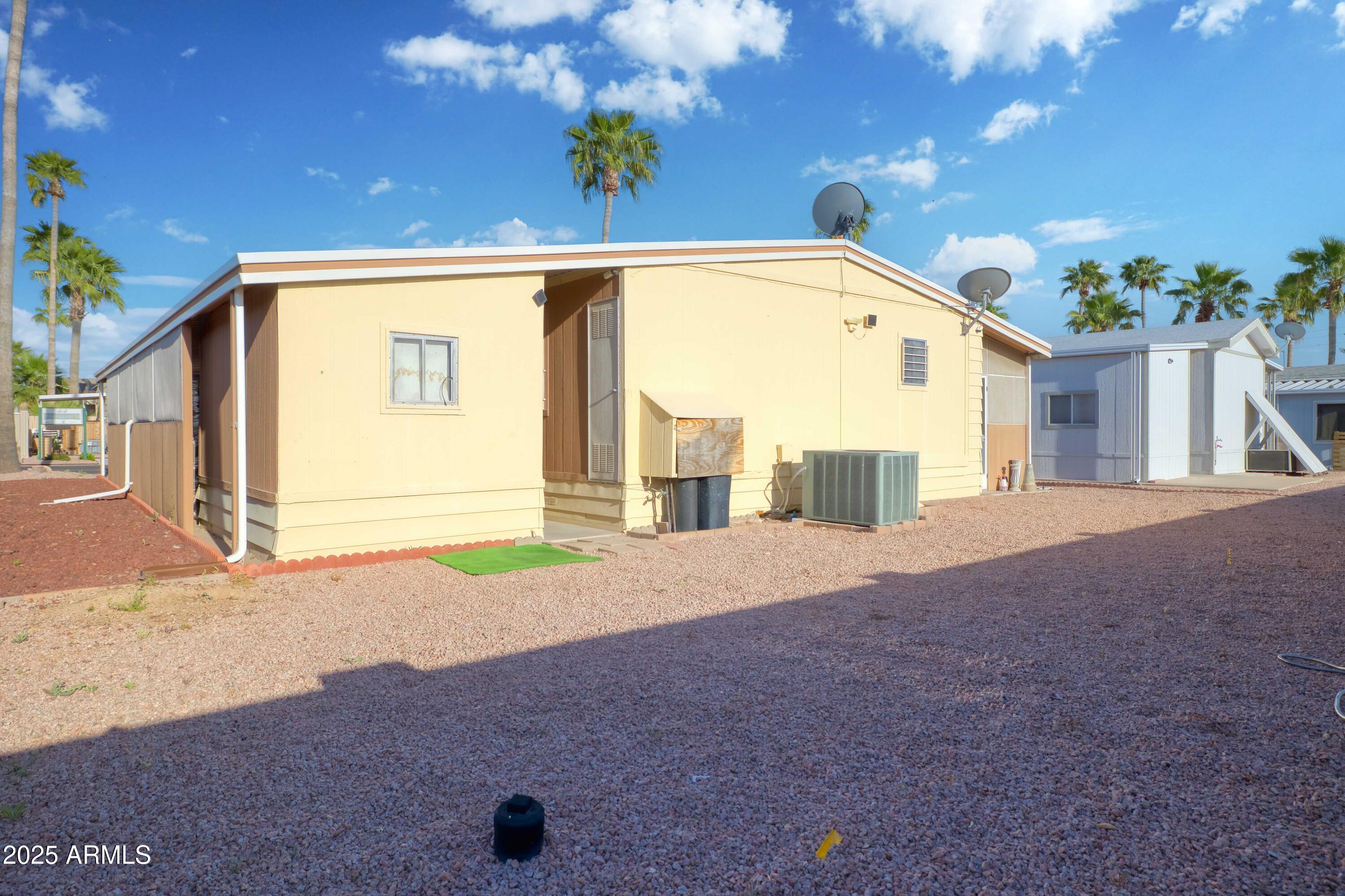 9302 East Broadway Road, Unit 185 Mesa, AZ 85208 - Photo 7 of 24 a front view of a house with a yard and garage