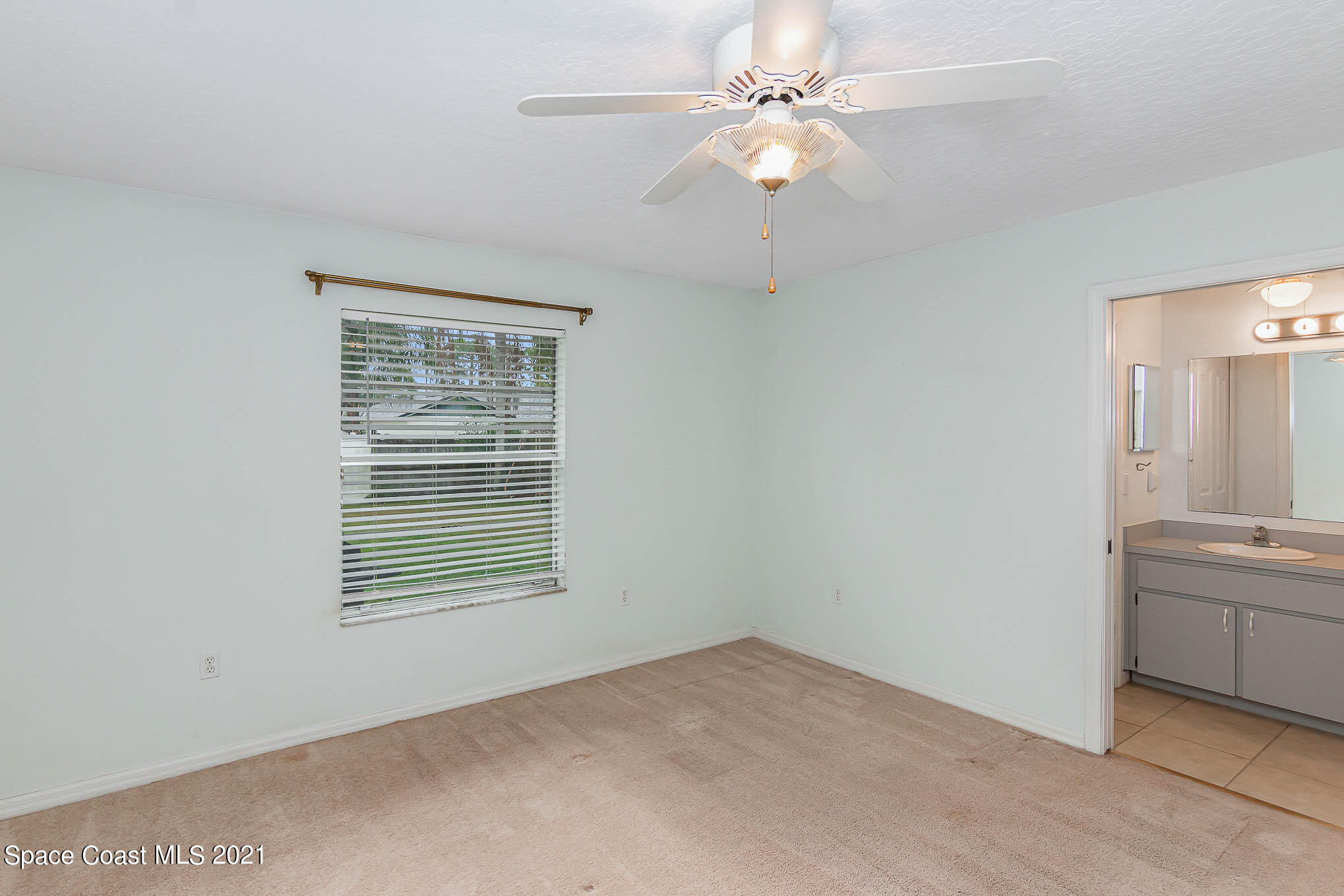 6755 Cairo Road Cocoa, FL 32927 - Photo 11 of 22 an empty room with a window and a fan