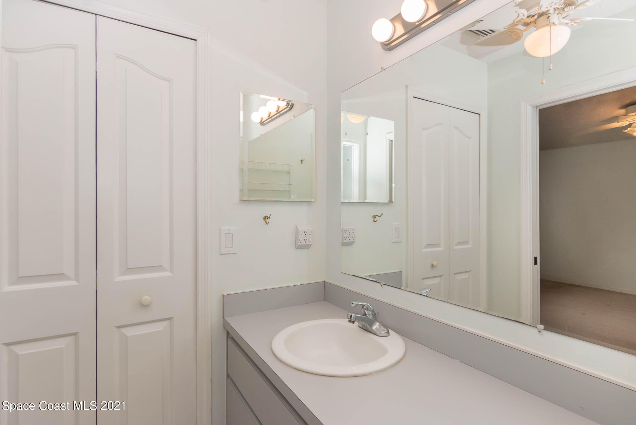 6755 Cairo Road Cocoa, FL 32927 - Photo 14 of 22 a bathroom with a sink a mirror and a shower