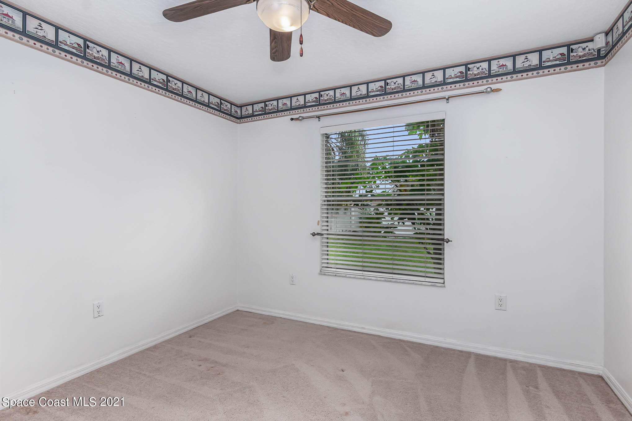 6755 Cairo Road Cocoa, FL 32927 - Photo 17 of 22 a view of a room with rack on the wall and a window