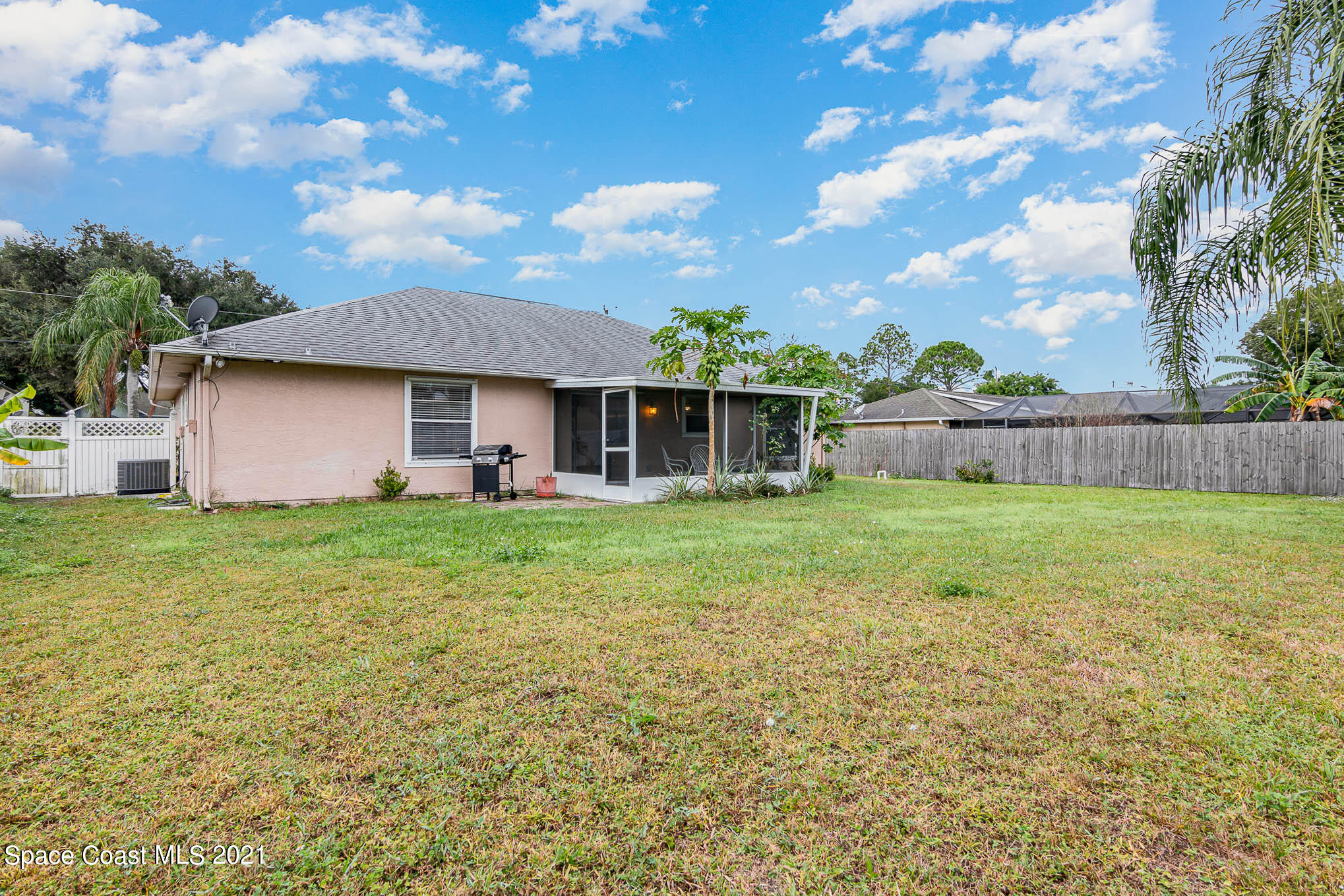 6755 Cairo Road Cocoa, FL 32927 - Photo 19 of 22 a front view of house with yard and trees in the background