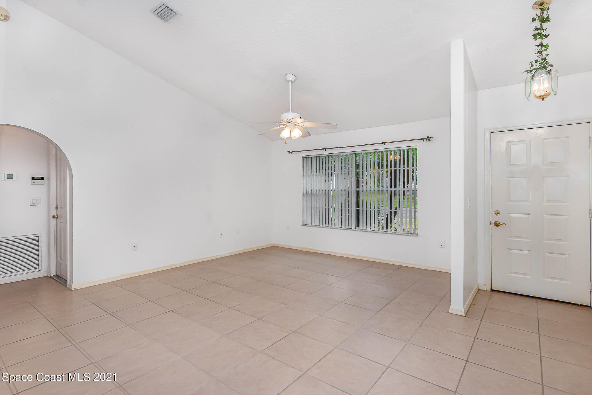 6755 Cairo Road Cocoa, FL 32927 - Photo 5 of 22 an empty room with windows and entrance