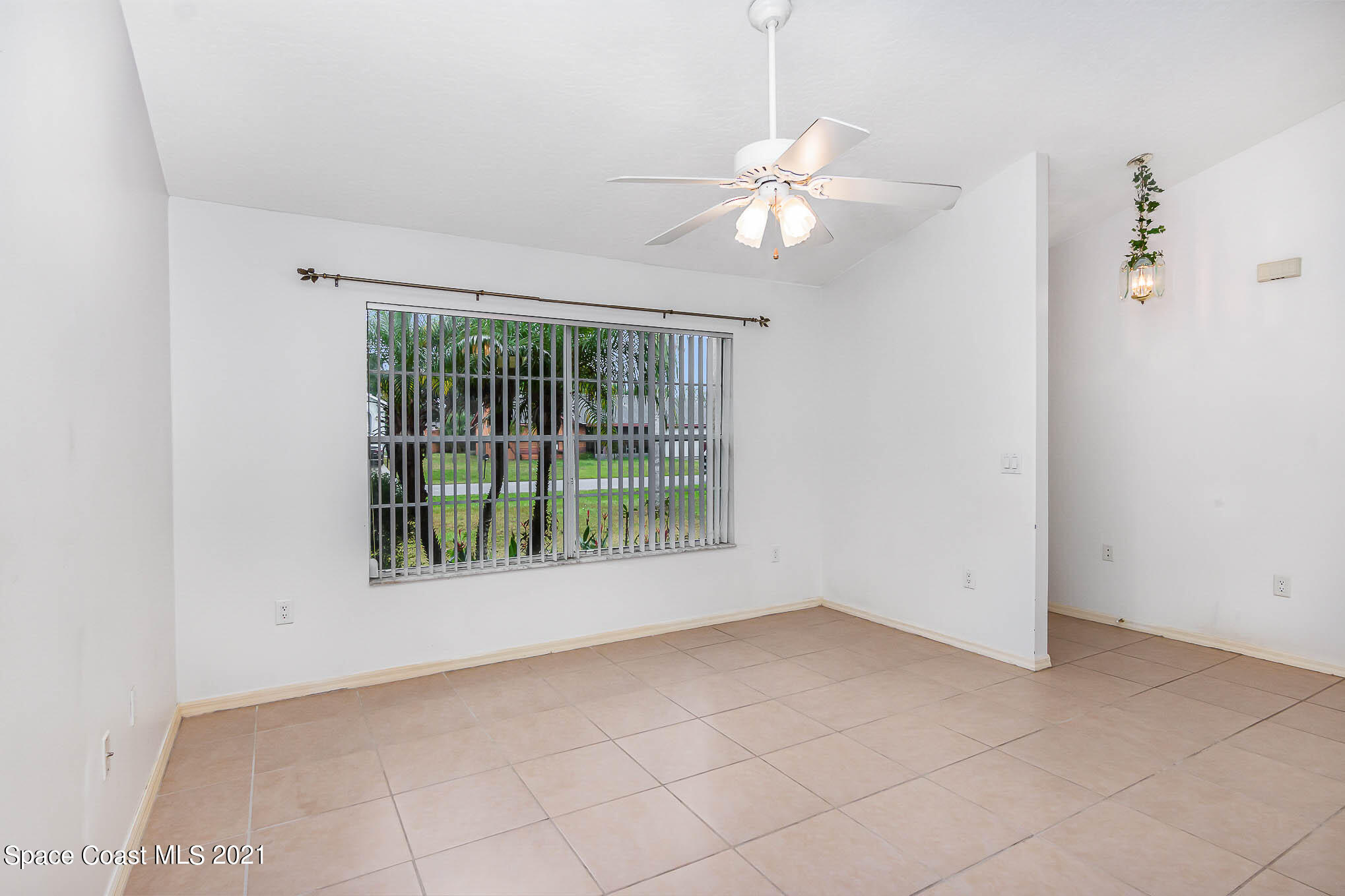 6755 Cairo Road Cocoa, FL 32927 - Photo 6 of 22 an empty room with windows and entrance