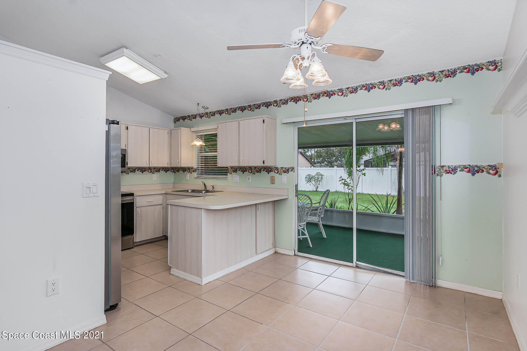 6755 Cairo Road Cocoa, FL 32927 - Photo 7 of 22 a kitchen with kitchen island granite countertop a stove a sink and cabinets