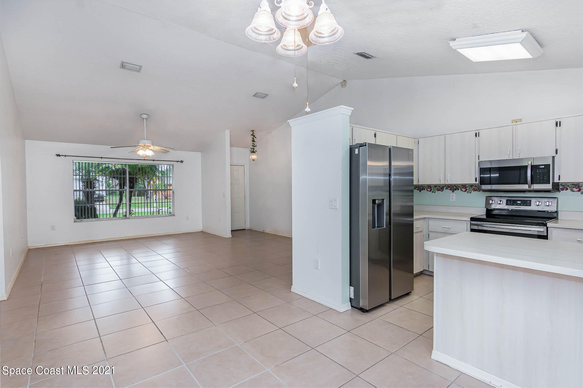 6755 Cairo Road Cocoa, FL 32927 - Photo 8 of 22 a kitchen with stainless steel appliances a refrigerator and a stove top oven